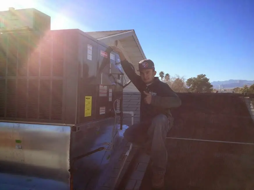 HVAC technician performing HVAC Inspection on a rooftop unit in Mechanicsburg